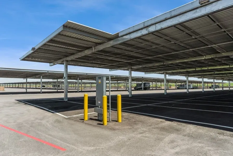 Empty lot of covered parking space with a utility panel in the foreground