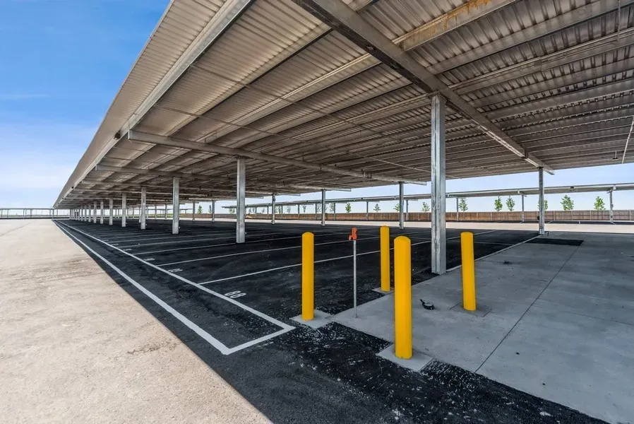 Empty lot of covered parking space with a black tank dump site in the foreground