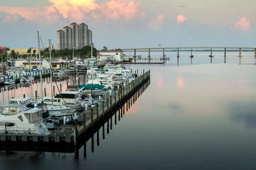 iew of boat dock and highway bridge in downtown Fort Myers, Florida.