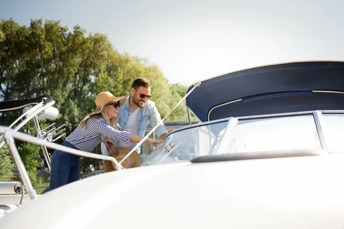 A couple inspecting their boat together.